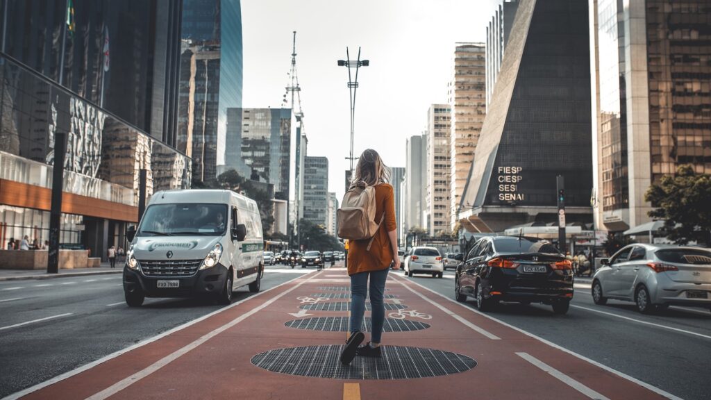 Photo of a woman walking in the busy streets of Avenida Paulista within the Brazilian city of Sao Paulo